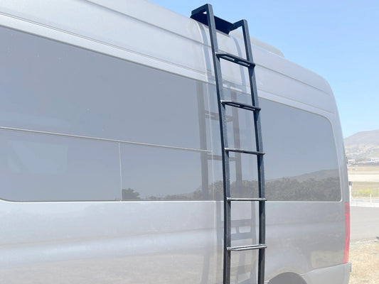 Black aluminum ladder attached to the side of a white van, designed for driver access.