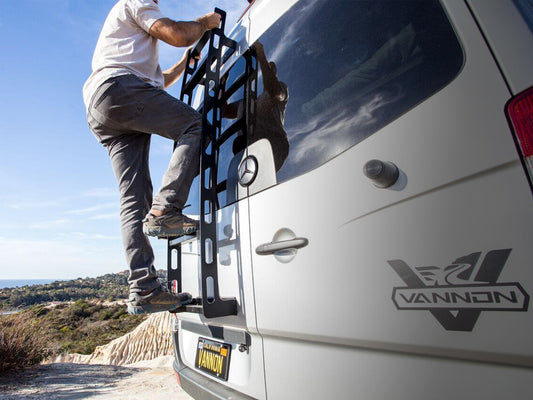 Man scales black aluminum ladder