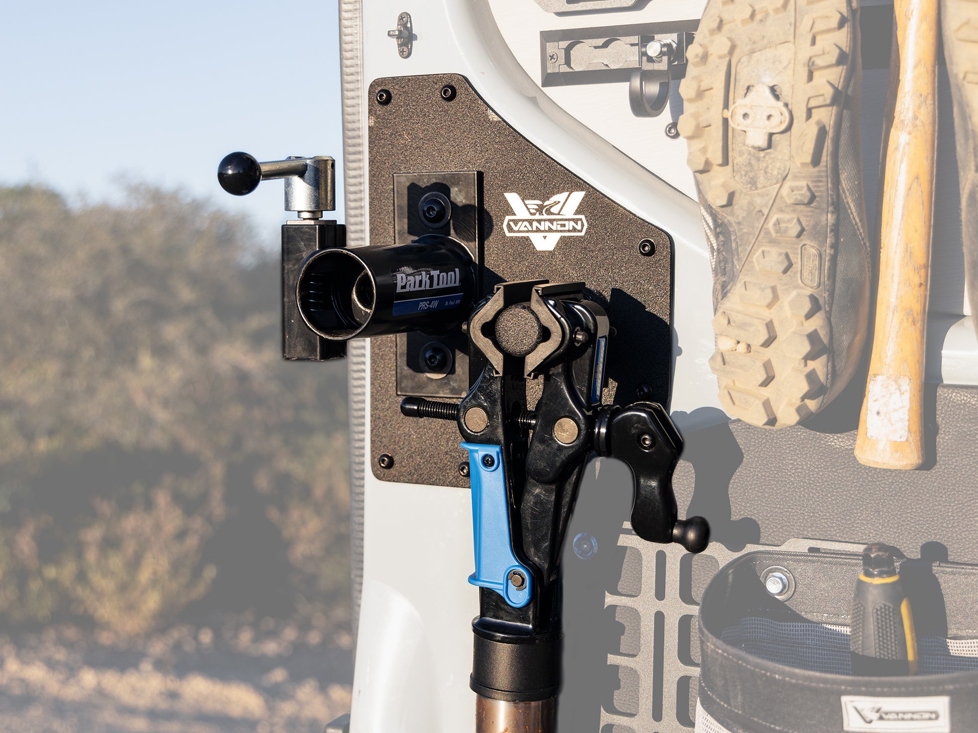 A Sprinter van rear door bike mount workstation attached to the vehicle's door, featuring aircraft grade aluminum supports and a textured powder-coat finish.