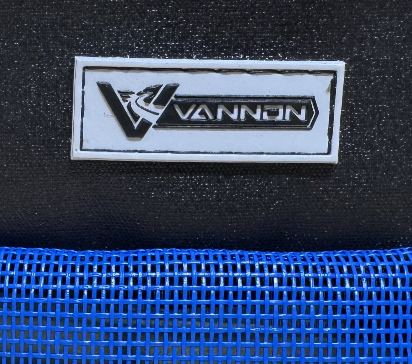 VANNON logo on a black background with blue mesh at the bottom