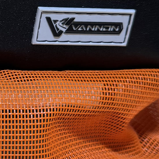 Close-up of a VANNON logo on a black background with orange mesh fabric.