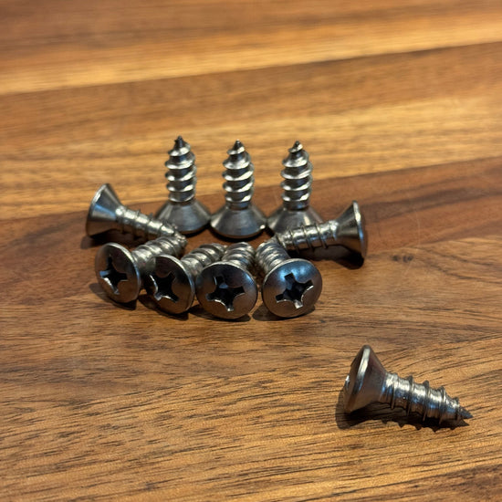 Collection of screws on a wooden surface