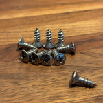 Collection of screws on a wooden surface