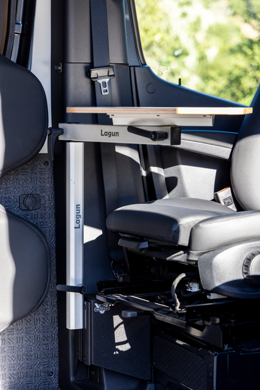 Van interior with a retractable table labeled 'Lagun' and a seat folded down.