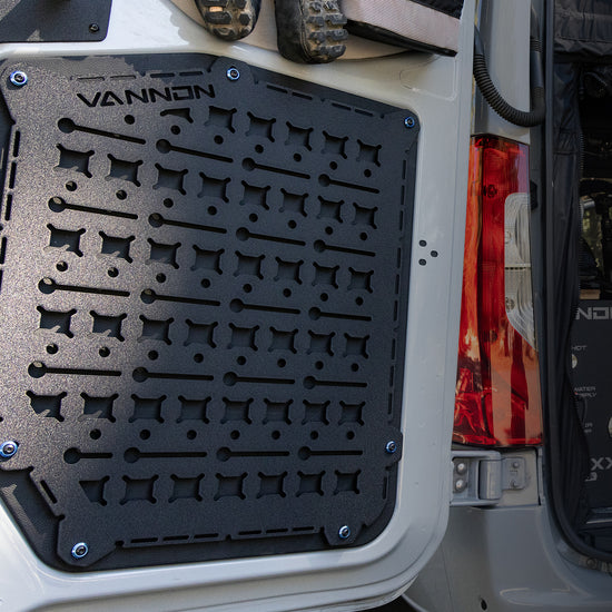 Black VANNON rear door Molle panel installed on the rear door of a vehicle, featuring multiple mounting points for attaching gear.