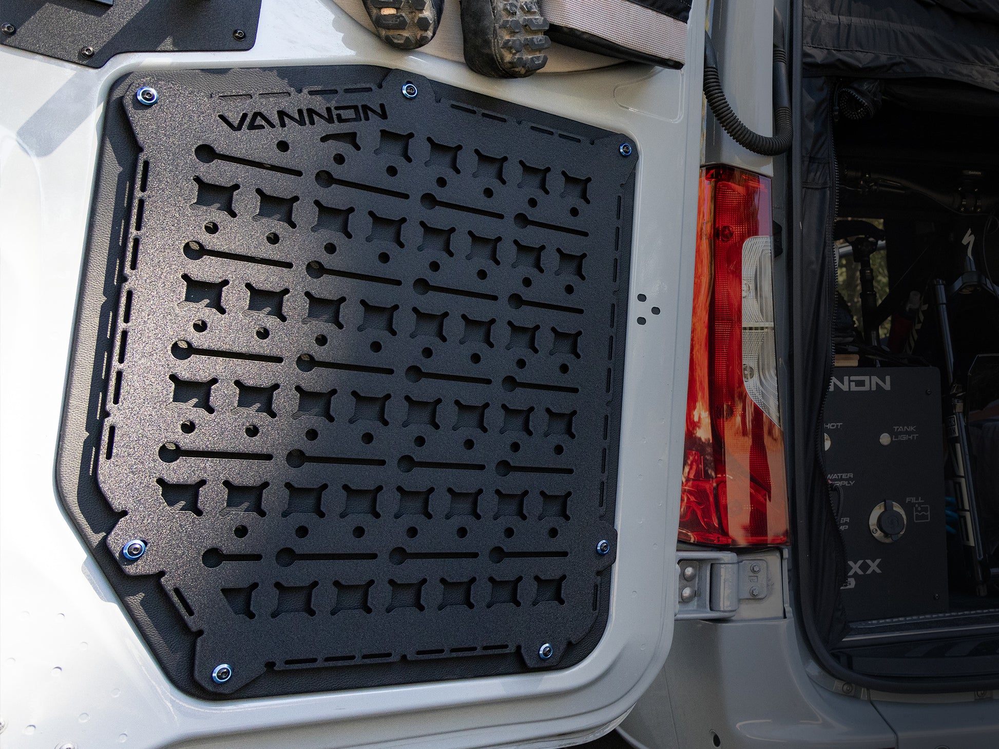 Black VANNON rear door Molle panel installed on the rear door of a vehicle, featuring multiple mounting points for attaching gear.