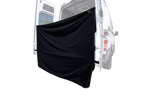 A black shower curtain installed on the rear side of a white VANNON van.